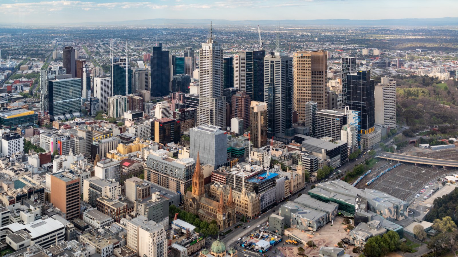 Melbourne’s CBD seen from Eureka Tower, with St Paul’s Cathedral and Flinders Street Station in the foreground.
